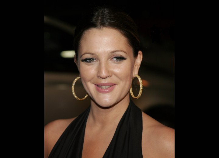 Drew Barrymore with her hair styled severely back