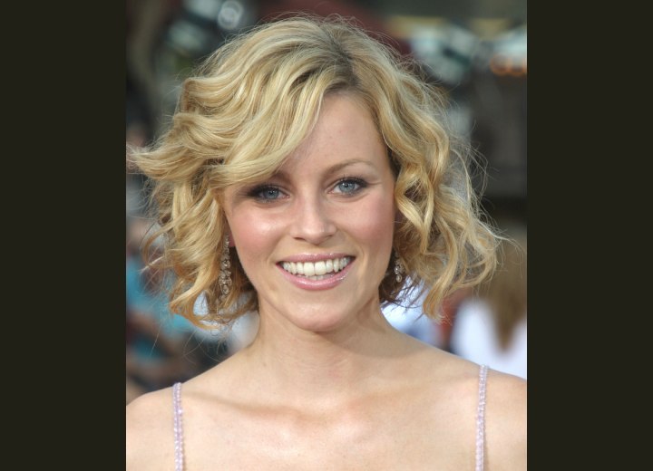 Elizabeth Banks wearing a mid-neck length bob haircut with curls