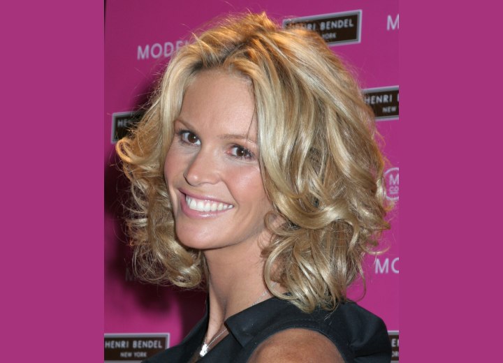 Side view of Elle MacPherson's medium hairstyle with curls