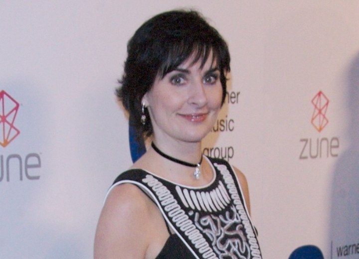 Enya - Short and conservative haircut that covers the ears