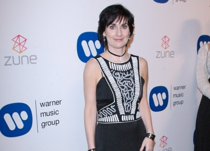 Enya wearing a black and white dress with long skirt