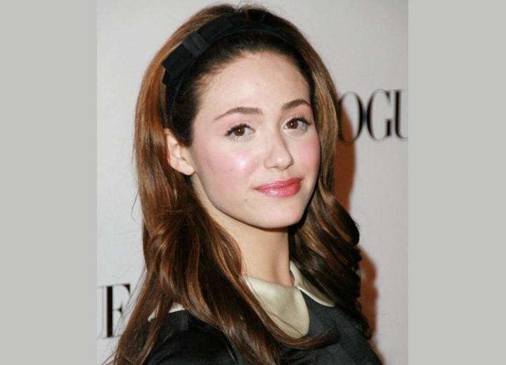 Long hair combed back and secured with a hairband - Emmy Rossum