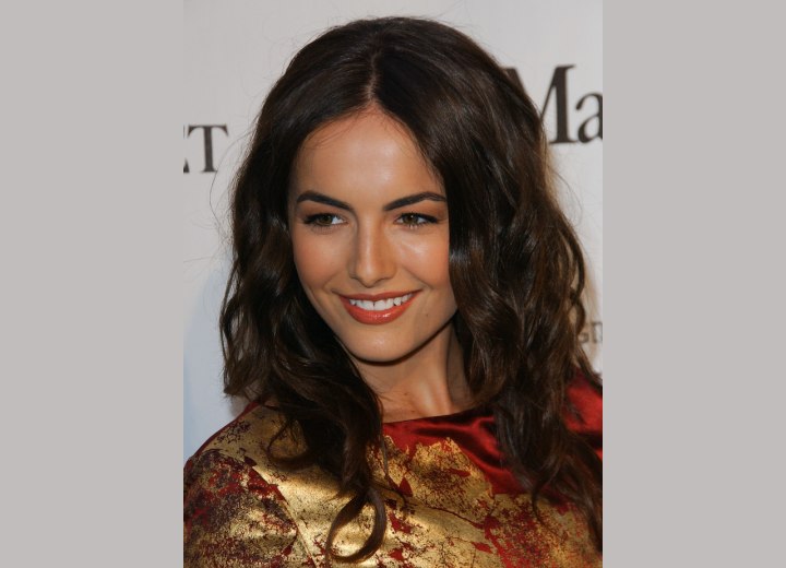 Long curly hairstyle with a middle section - Camilla Belle