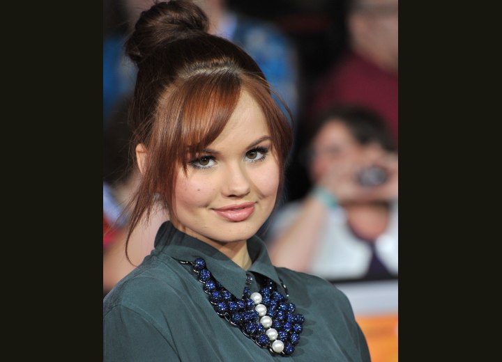 Debby Ryan - Top knot hairstyle with loose bangs