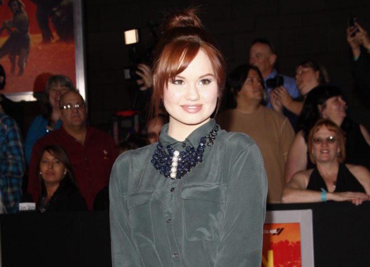 Debby Ryan wearing a silk shirt with buttoned-up collar