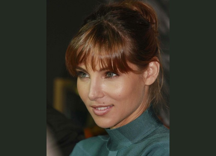 Elsa Pataky wearing her hair in an updo with blunt cut bangs