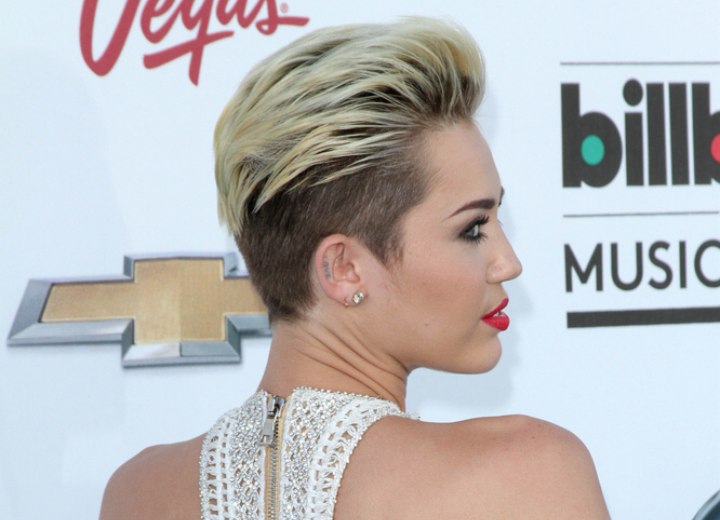 Miley Cyrus with her hair buzzed close to the scalp