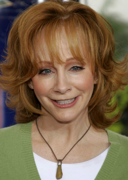 Reba McEntire's practical and bouncy red hair with flipped out ends