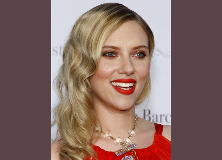 Scarlett Johansson with her blonde hair styled into spiral curls