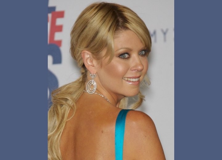 Tara Reid with her hair gathered to a ponytail
