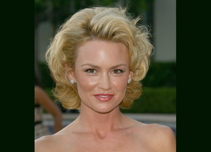 Kelly Carlson with short curled hair