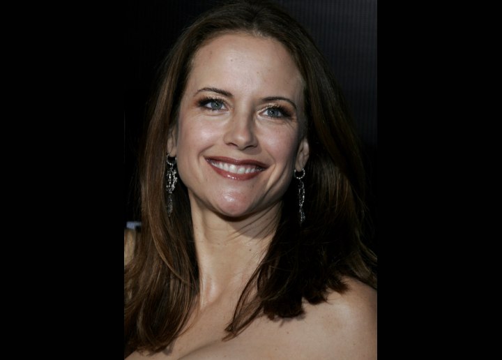 Kelly Preston's long hair styled with a flip