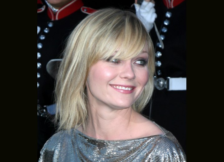Kirsten Dunst's hairstyle with a long fringe