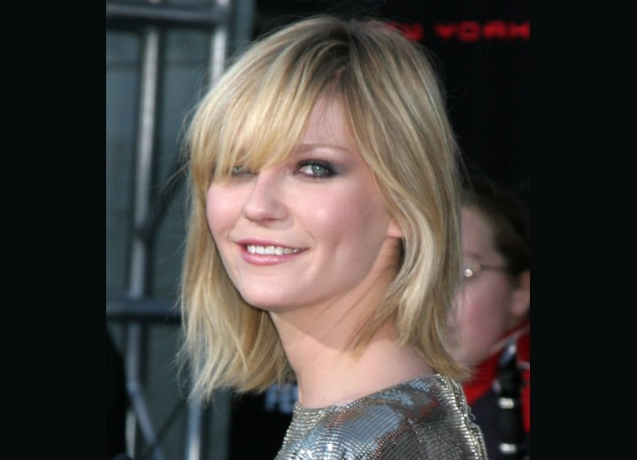 Kirsten Dunst with textured hair and long bangs