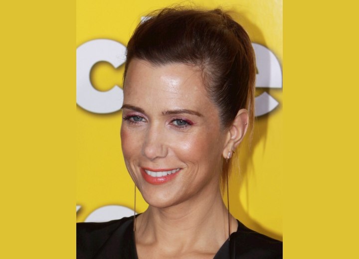 Kristen Wiig with her hair severely pulled back