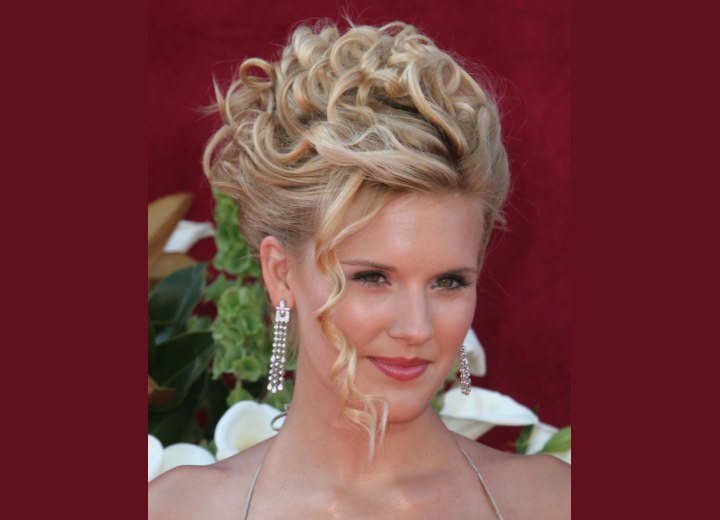 Maggie Grace's hair in an updo with tendrils around her face