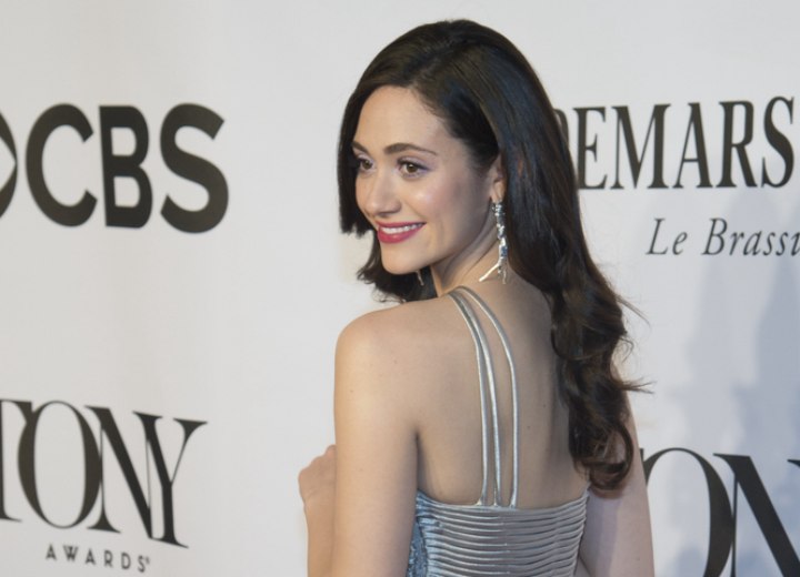 Emmy Rossum with her long hair styled in uniform curls