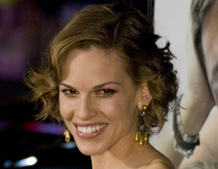 Hilary Swank with short curled hair