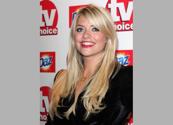 Holly Willoughby's long hairstyle with an off center part