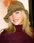 Sarah Chalke sporting long blonde hair and wearing a hat