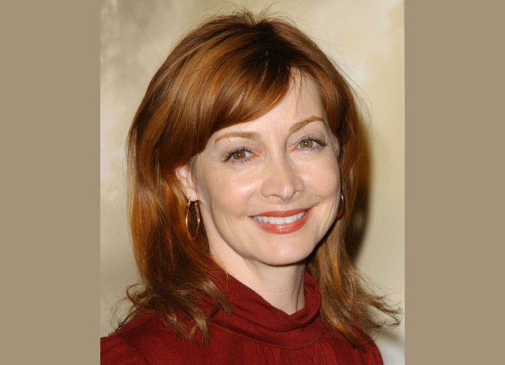Sharon Lawrence with auburn hair that corresponds with the color of her eyes