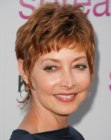 Sharon Lawrence with her hair cut short in a pixie with bangs