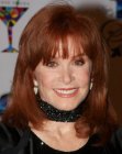 Stephanie Powers wearing her hair at shoulder length and layered all over
