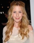 Tara Lipinski's long hairstyle with curls that opens up her face
