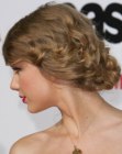 Taylor Swift wearing her hair up and braided