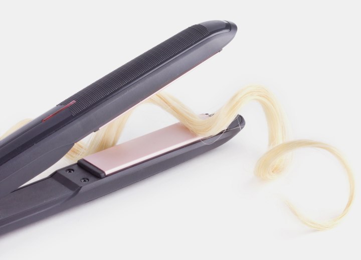 Curly lock of hair and flat iron