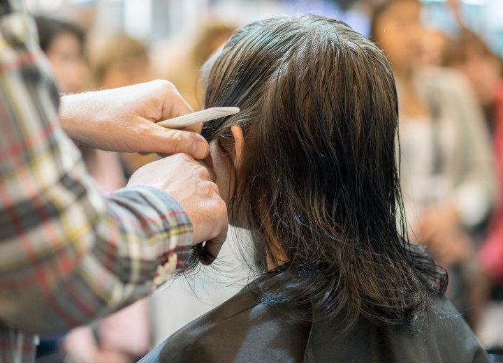 Hairdresser cutting a shag with layers