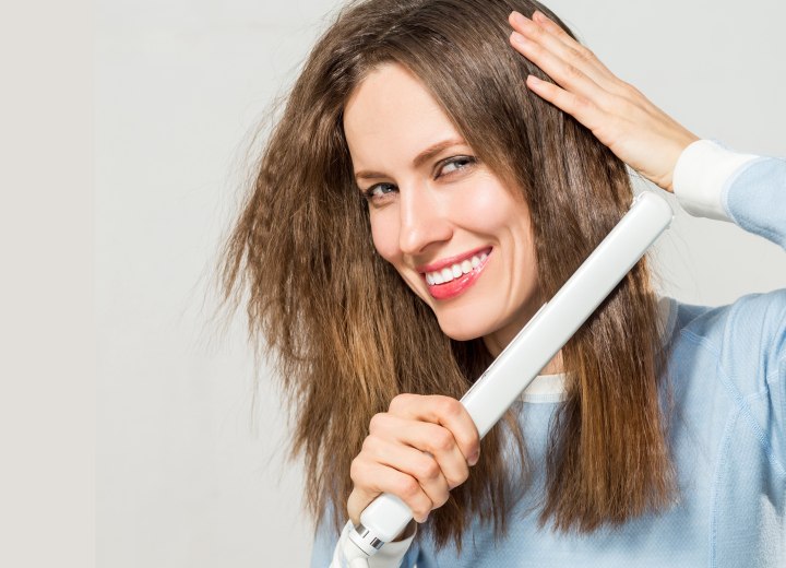 Woman who is straightening her hair