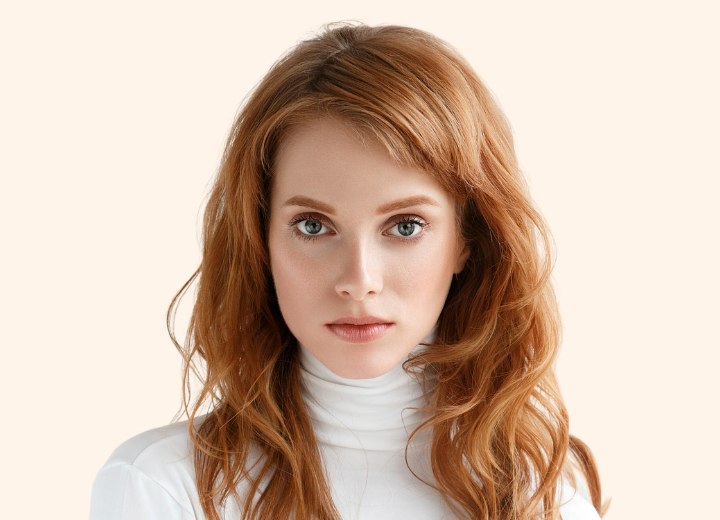 Woman with red hair who is wearing a white turtleneck