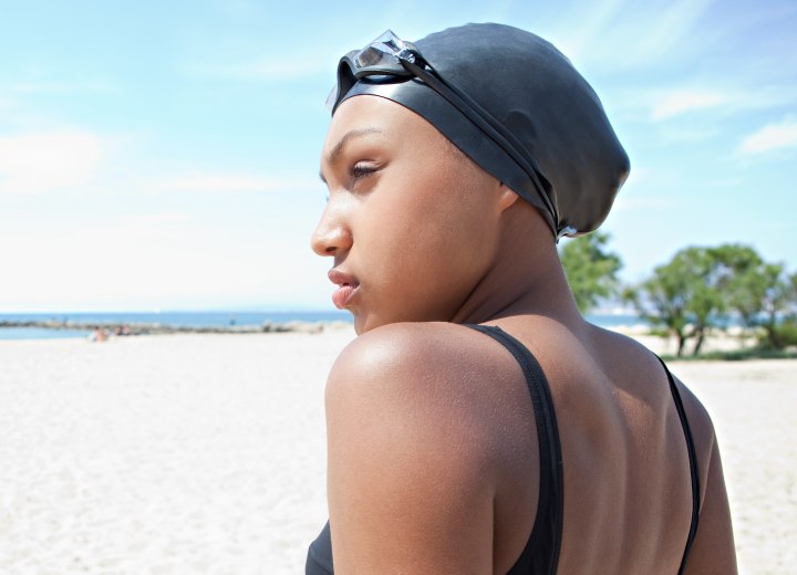 African woman wearing a swim cap to protect her hair