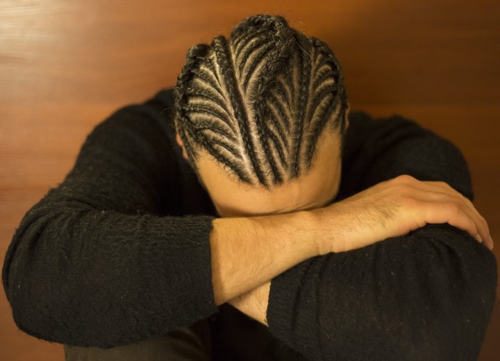 Man with his hair styled in cornrow braids