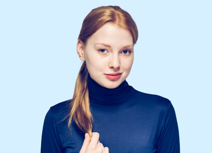 Young woman with turtleneck and ponytail before cutting her hair in a pixie
