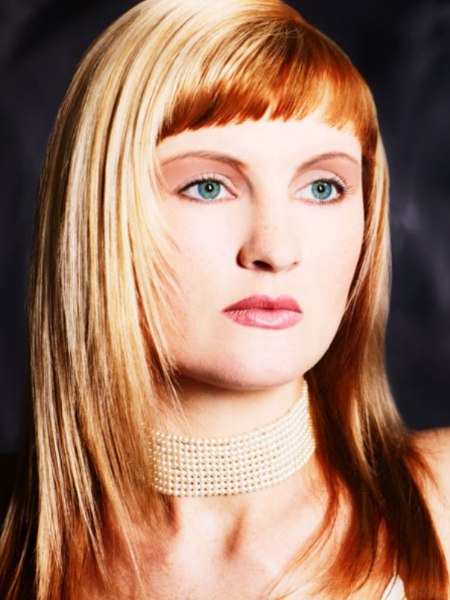 Strawberry blonde hair with high blunted bangs