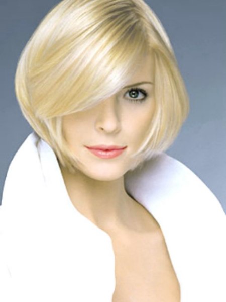 Short rounded bob with tapered lines and low swinging bangs