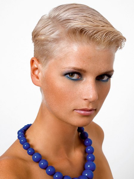 Very short female haircut styled with wet look gel