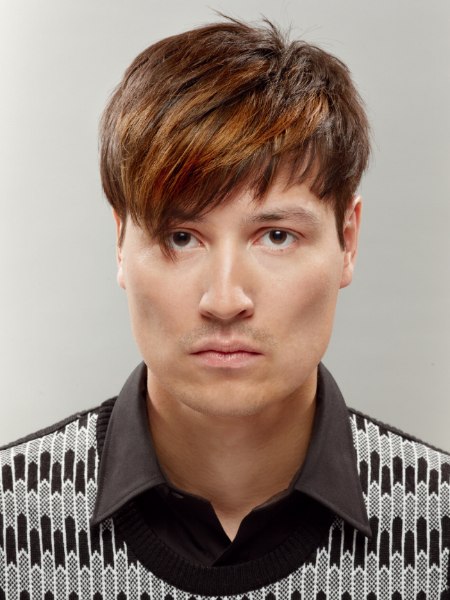 Mens haircut with the fringe styled down and the sides towards the face