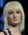Hairstyle with round cutout bangs that forms an arch around the face