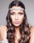 Long curled hair and a headpiece with crystals