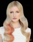 Platinum blonde hair with color accents and loose waves