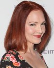 Amy Yasbeck with her red hair in a bob