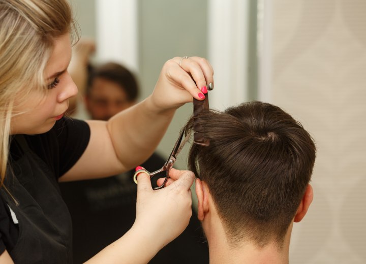 Hairdresser cutting a Cambridge cut for men