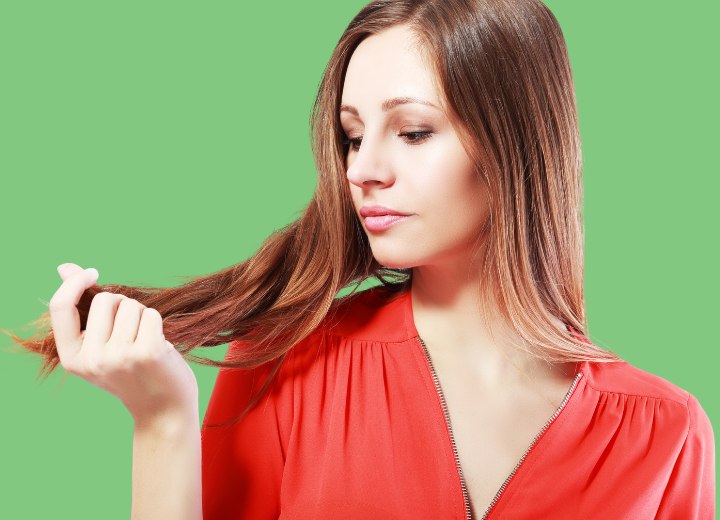 Woman who is checking for first gray hairs