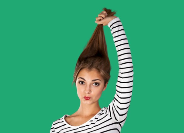Girl trying to stretch her hair to test elasticity