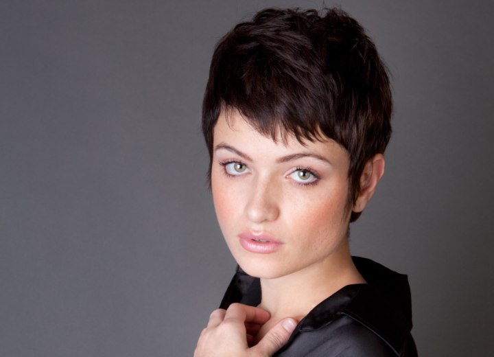 Woman with pixie-short hair and wearing a nylon blouse
