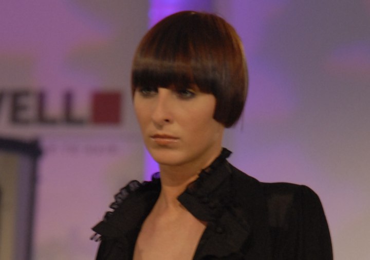 hairstyle with bangs below the brow