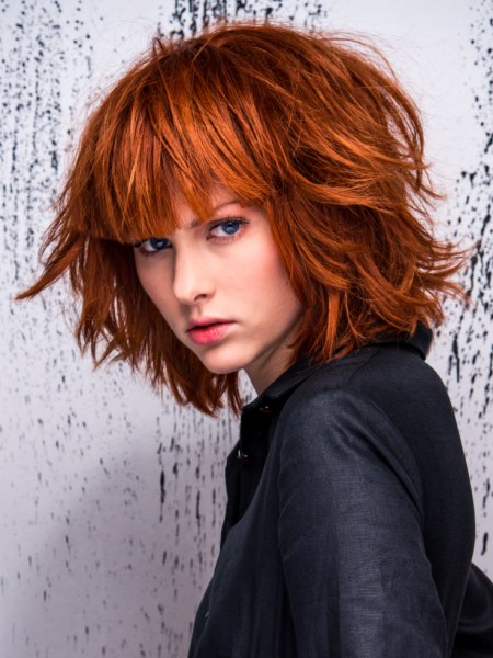 Red hair in a mid-length bob with a long straight fringe